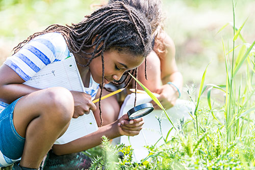 Young girl with magnifying glass