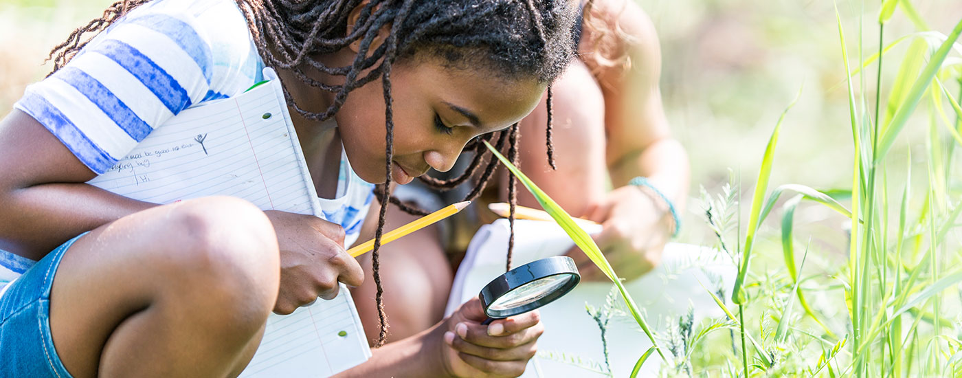 Young girl with magnifying glass